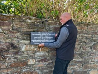 Clive Benney placing the plaque at Rosemundy former mother and baby home